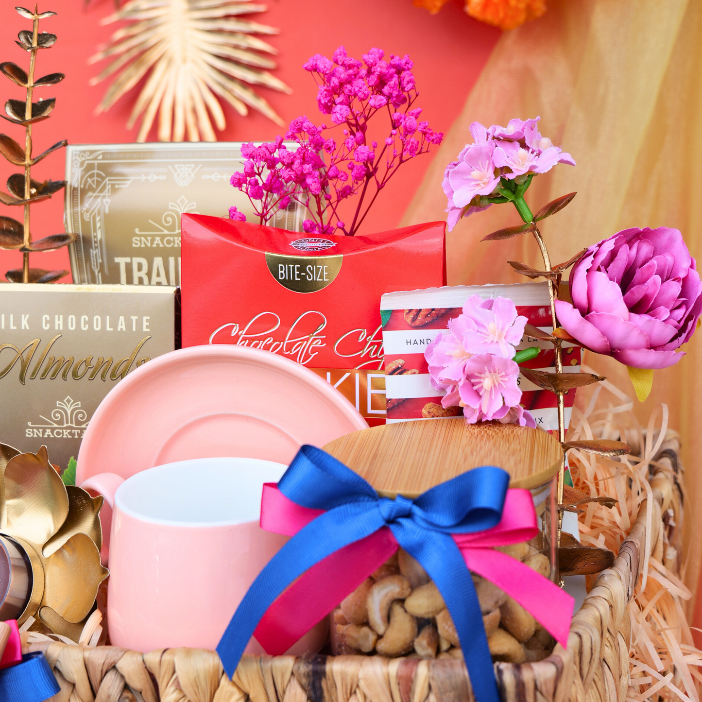 Gift basket with pink mug, cookies, and flowers on a colorful background