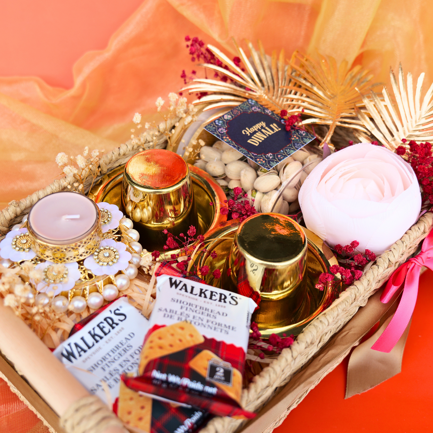 Gift basket with candles, crackers, and decorative items on a bright background
