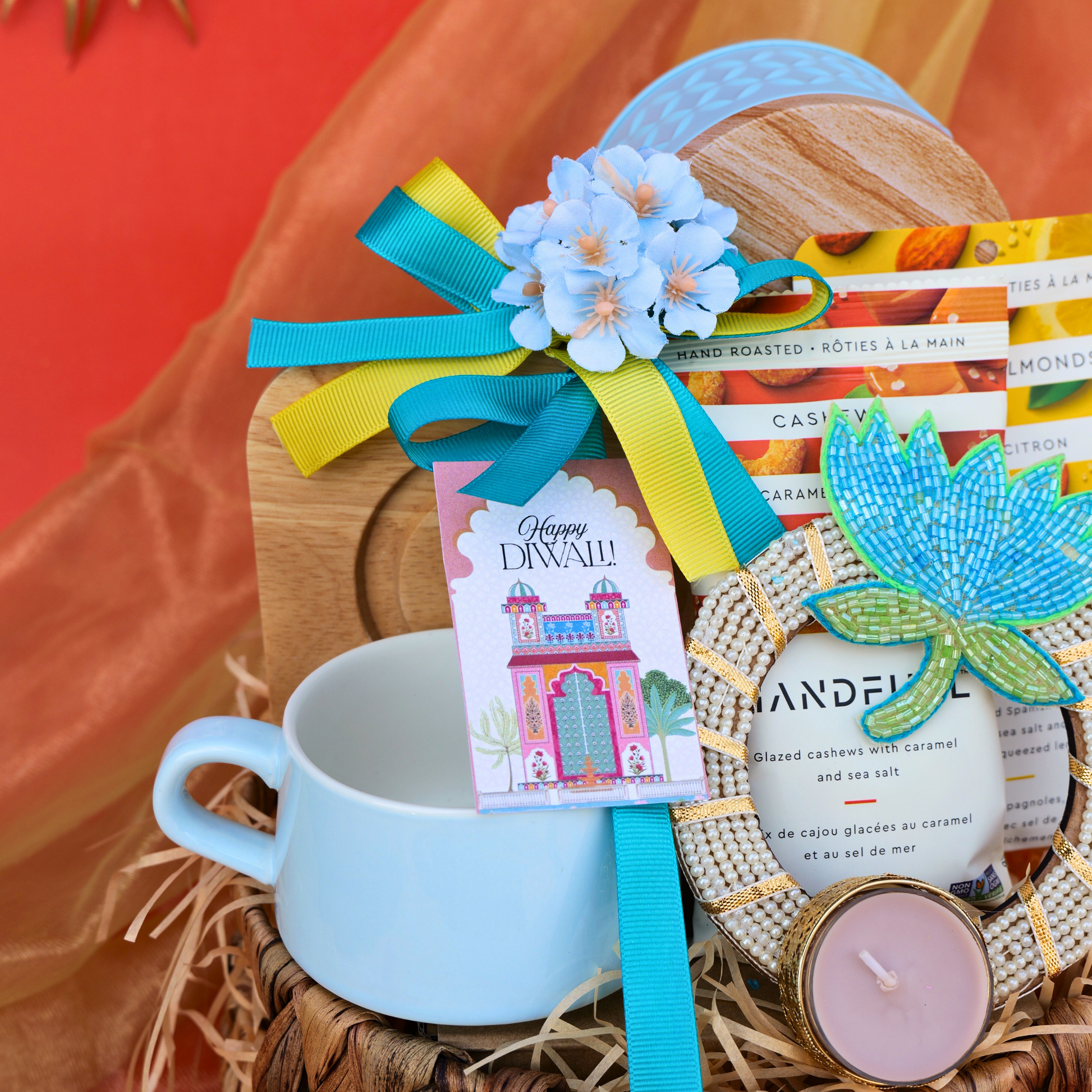 Gift basket with a mug, candle, and decorative items on a textured surface