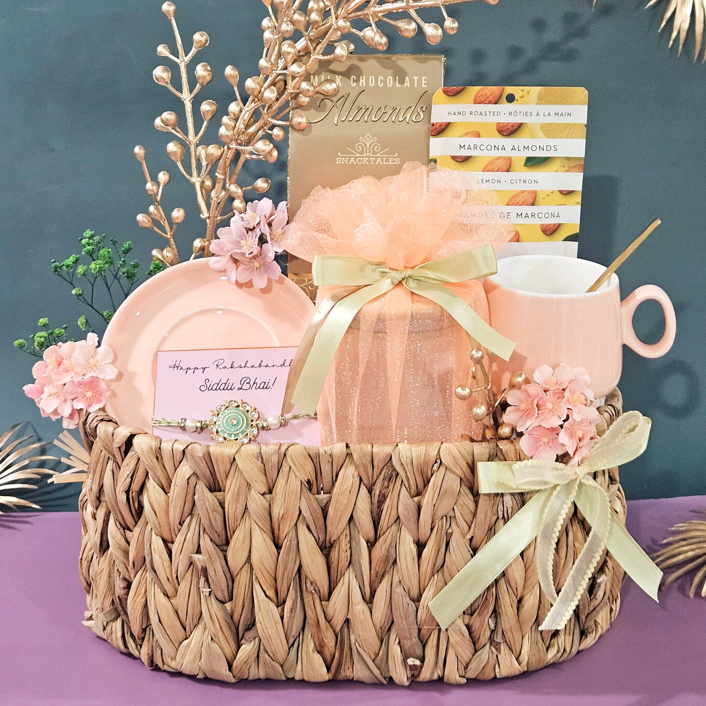 Gift basket with pink mug, soap, and flowers on a purple surface